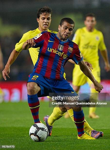 Daniel Alves of FC Barcelona competes for the ball with Nilmar of Villarreal CF during the La Liga match between Villarreal CF and FC Barcelona at El...
