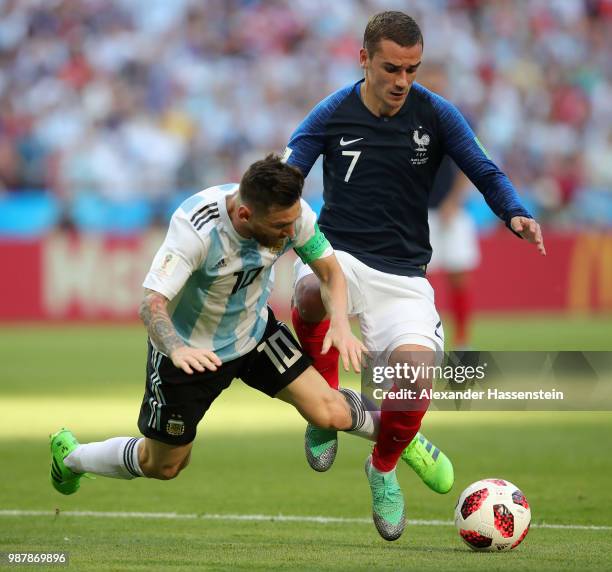 Lionel Messi of Argentina and Antoine Griezmann of France clash during the 2018 FIFA World Cup Russia Round of 16 match between France and Argentina...