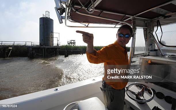 Local boat operator shows old oil storage facilities as the clean-up operation from the BP Deepwater Horizon platform disaster continues in the...