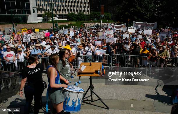 People gather in Foley square as they attend the nationwide "Families Belong Together" march on June 30, 2018 in New York City. As thousands of...