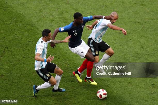 Paul Pogba of France is challenged by Javier Mascherano and Angel Di Maria of Argentina during the 2018 FIFA World Cup Russia Round of 16 match...