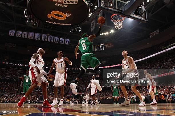 Rajon Rondo of the Boston Celtics glides in for the lay-in defended by Mo Williams, Antawn Jamison and Zydrunas Ilgauskas of the Cleveland Cavaliers...