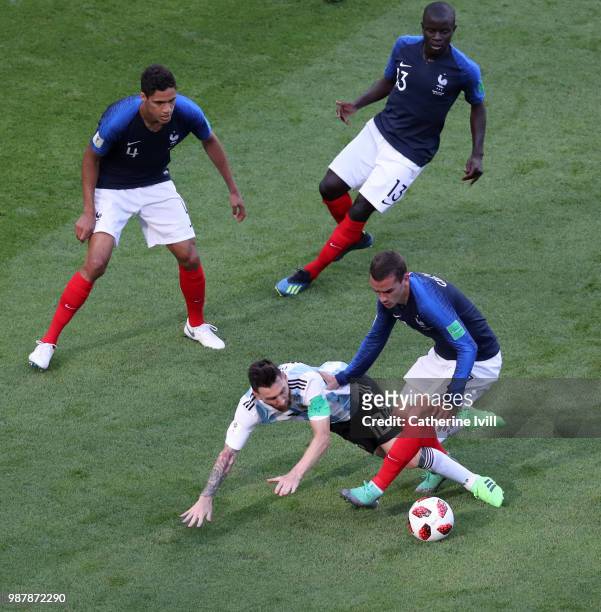 Lionel Messi of Argentina is fouled by Antoine Griezmann of France during the 2018 FIFA World Cup Russia Round of 16 match between France and...