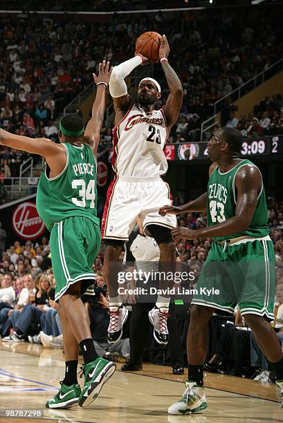 LeBron James of the Cleveland Cavaliers shoots over Paul Pierce and Kendrick Perkins of the Boston Celtics in Game One of the Eastern Conference...