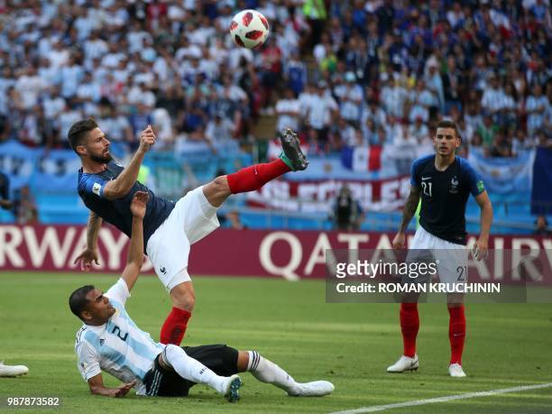 France's forward Olivier Giroud vies for the ball with Argentina's defender Gabriel Mercado during the Russia 2018 World Cup round of 16 football...