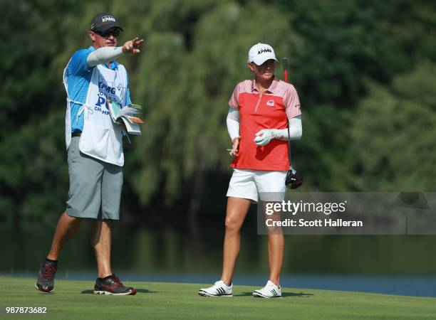 Stacy Lewis lines up her tee shot on the seventh hole with her caddie Travis Wilson during the third round of the KPMG Women's PGA Championship at...