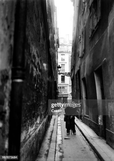 Man walks on Venise street in Paris on March 21, 1947.