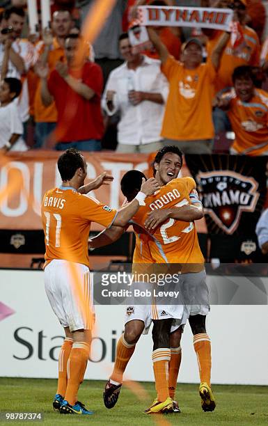 Luis Landin, rear, of the Houston Dynamo celebrates with Dominic Oduro and Brad Davis after scoring in the first half against the Kansas City Wizards...
