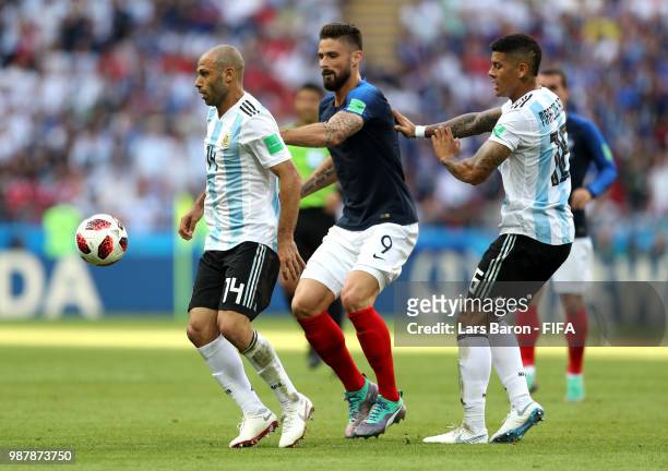 Javier Mascherano of Argentina is challenged by Olivier Giroud of France during the 2018 FIFA World Cup Russia Round of 16 match between France and...