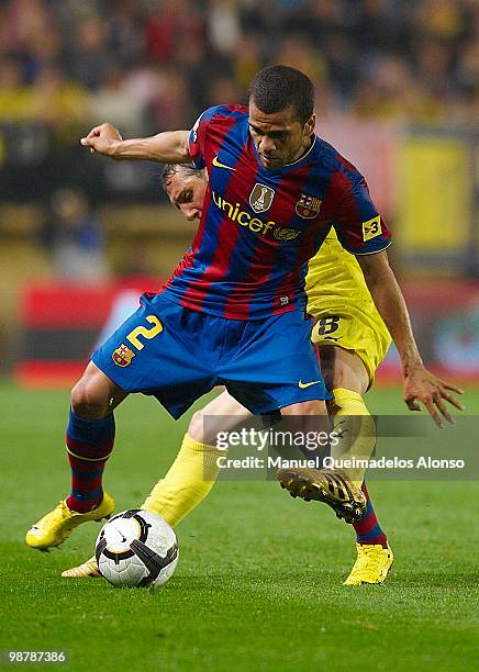 Daniel Alves of FC Barcelona competes for the ball with Santi Cazorla of Villarreal CF during the La Liga match between Villarreal CF and FC...