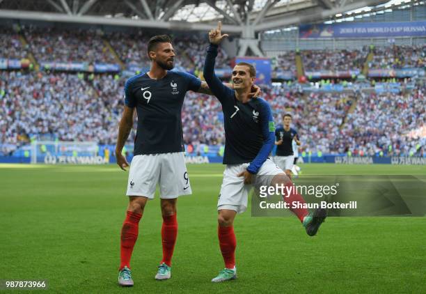 Antoine Griezmann of France celebrates with teammate Olivier Giroud after scoring his team's first goal during the 2018 FIFA World Cup Russia Round...