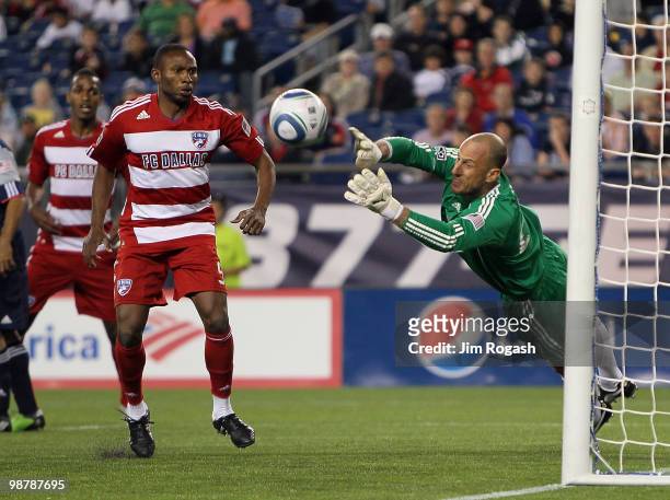 Jeff Cunningham of FC Dallas presses goalie Preston Burpo of the New England Revolution, who makes a save late in the second half, at Gillette...