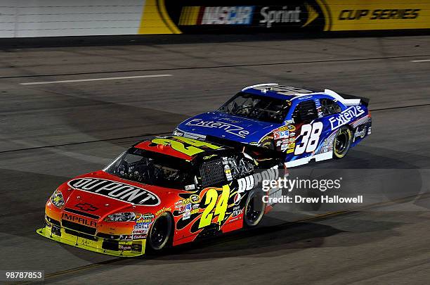 Jeff Gordon, driver of the DuPont Chevrolet, leads Kevin Conway, driver of the Extenze Ford, during the NASCAR Sprint Cup Series Crown Royal Presents...