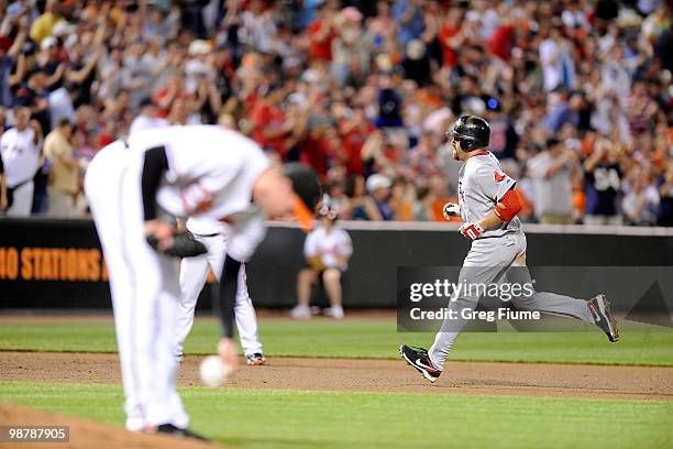 Kevin Youkilis of the Boston Red Sox rounds the bases after hitting a home run in the seventh inning against Mark Hendrickson of the Baltimore...
