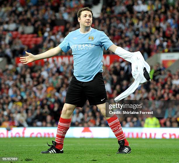 Jason Manford strips off shirt to reveal rival team Manchester City shirt while playing football at United For Relief: The Big Red Family Day Out at...