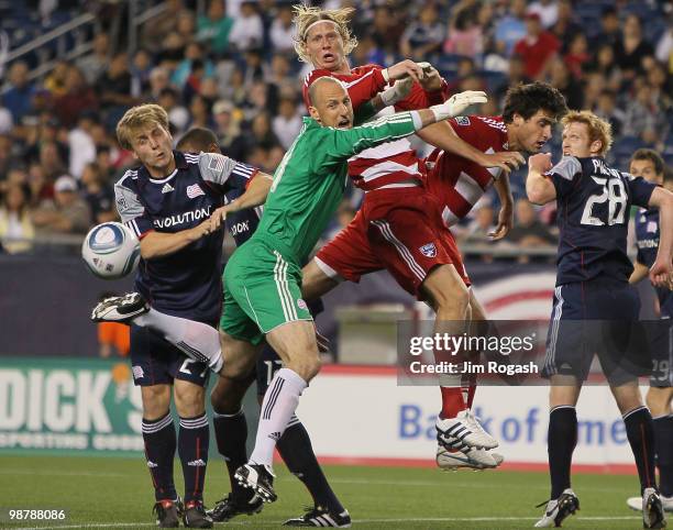 Brek Shea and Heath Pearce of FC Dallas press goalie Preston Burpo and defender Seth Sinovic, both of the New England Revolution at Gillette Stadium...