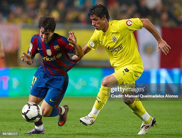 Bojan Krkic of FC Barcelona competes for the ball withJoan Capdevila of Villarreal CF during the La Liga match between Villarreal CF and FC Barcelona...