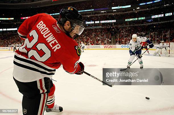 Troy Brouwer of the Chicago Blackhawks fires a shot at Sami Salo and Roberto Luongo of the Vancouver Canucks in Game One of the Western Conference...