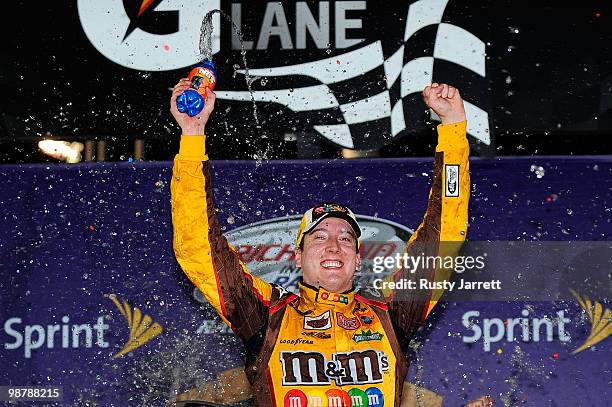 Kyle Busch, driver of the M&M's Toyota, celebrates in victory lane after he won the NASCAR Sprint Cup Series Crown Royal Presents the Heath Calhoun...