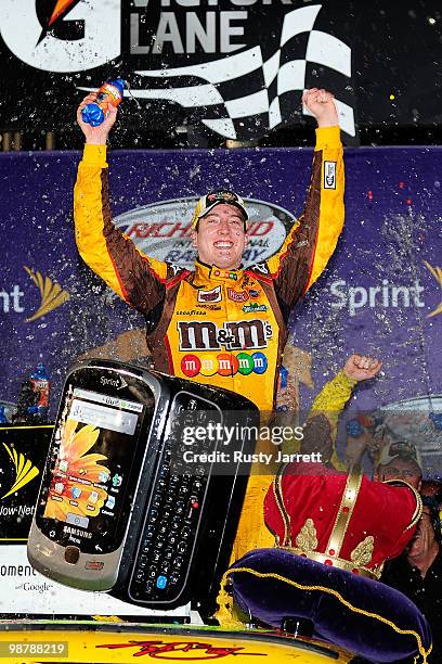 Kyle Busch, driver of the M&M's Toyota, celebrates in victory lane after he won the NASCAR Sprint Cup Series Crown Royal Presents the Heath Calhoun...