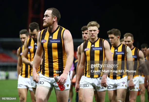 Jarryd Roughead of the Hawks and team mates look dejected after the round 15 AFL match between the Greater Western Sydney Giants and the Hawthorn...