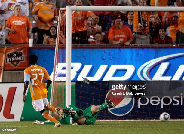 Samuel Appiah of the Houston Dynamo pushes the ball past a diving goalkeeper Jimmy NIelsen of the Kansas City Wizards in the second half at Robertson...