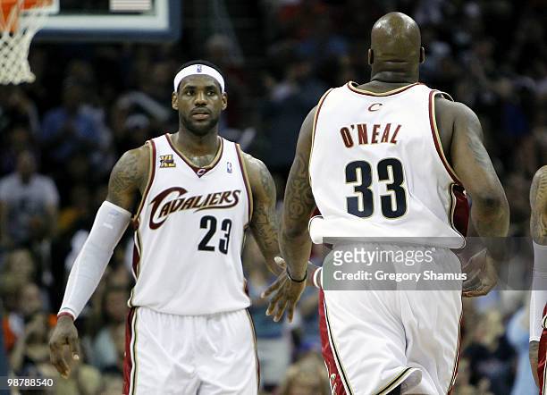 LeBron James of the Cleveland Cavaliers congratulates Shaquille O'Neal after his basket against the Boston Celtics during Game One of the Eastern...