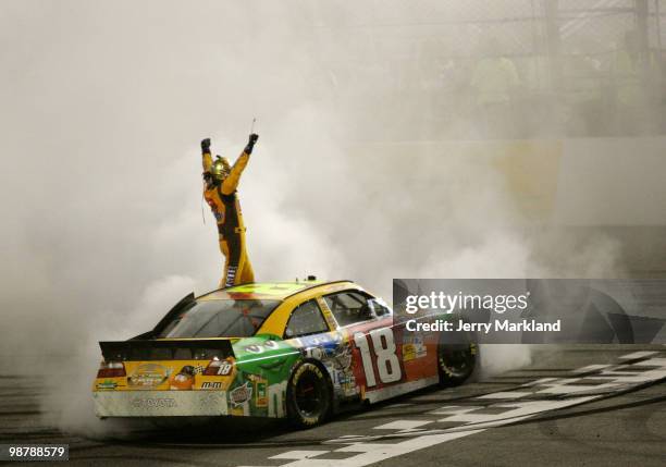 Kyle Busch, driver of the M&M's Toyota, celebrates winning the NASCAR Sprint Cup Series Crown Royal Presents the Heath Calhoun 400 at Richmond...