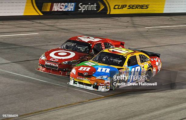 Kyle Busch, driver of the M&M's Toyota, leads Juan Pablo Montoya, driver of the Target Chevrolet, during the NASCAR Sprint Cup Series Crown Royal...
