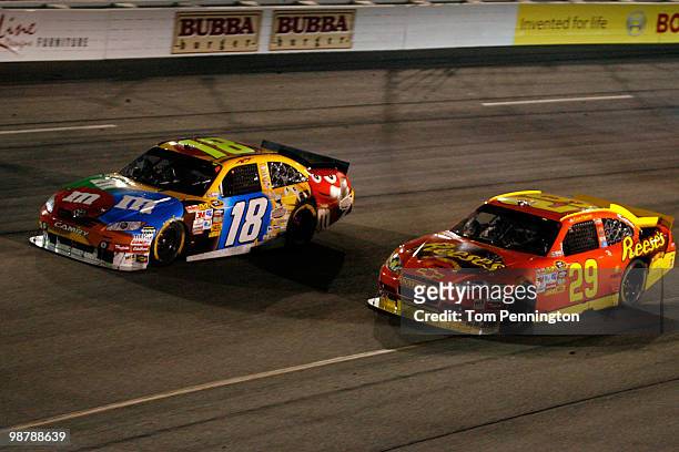 Kyle Busch, driver of the M&M's Toyota, races Kevin Harvick, driver of the Reese's Chevrolet during the NASCAR Sprint Cup Series Crown Royal Presents...