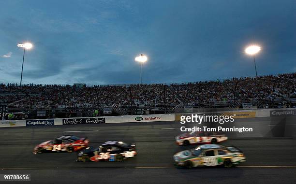 Drivers race through turn two under the lights during the NASCAR Sprint Cup Series Crown Royal Presents the Heath Calhoun 400 at Richmond...