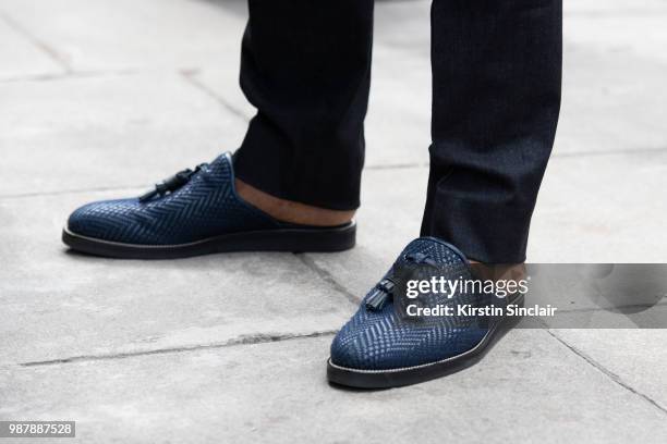 Ballet dancer Eric Underwood wears Kilgor trousers and Christian Louboutin shoes during London Fashion Week Men's on June 10, 2018 in London, England.