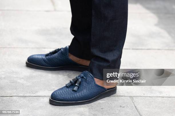 Ballet dancer Eric Underwood wears Kilgor trousers and Christian Louboutin shoes during London Fashion Week Men's on June 10, 2018 in London, England.
