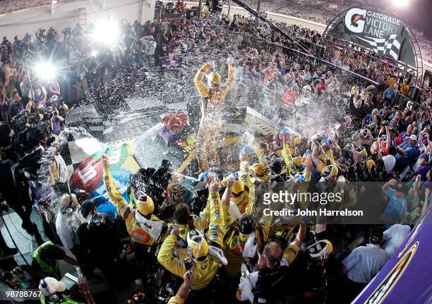 Kyle Busch, driver of the M&M's Toyota, celebrates with his crew in victory lane after he won the NASCAR Sprint Cup Series Crown Royal Presents the...