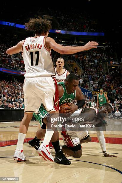 Glen Davis of the Boston Celtics grabs a loose ball between Anderson Varejao and J.J. Hickson of the Cleveland Cavaliers in Game One of the Eastern...