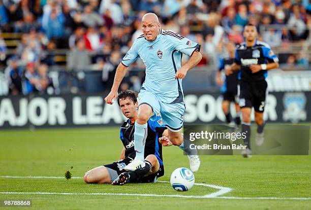 Forward Conor Casey of the Colorado Rapids takes control of the ball just outside the penalty box despite the attempt to kick it away by defender...