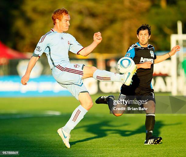 Midfielder Jeff Larentowicz of the Colorado Rapids knocks the ball over the head of midfielder Ramon Sanchez of the San Jose Earthquakes in the first...