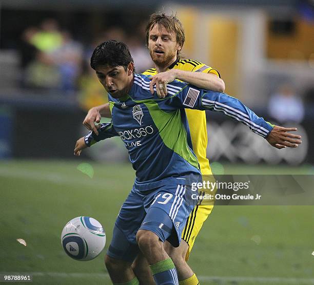 Leonardo Gonzalez of of the Seattle Sounders FC battles Eddie Gaven of the Columbus Crew on May 1, 2010 at Qwest Field in Seattle, Washington.