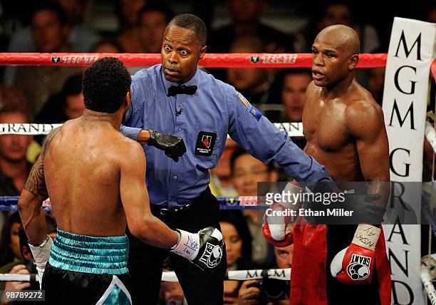 Referee Kenny Bayless looks over at Shane Mosley as he gets between Mosley and Floyd Mayweather Jr. During the welterweight fight at the MGM Grand...