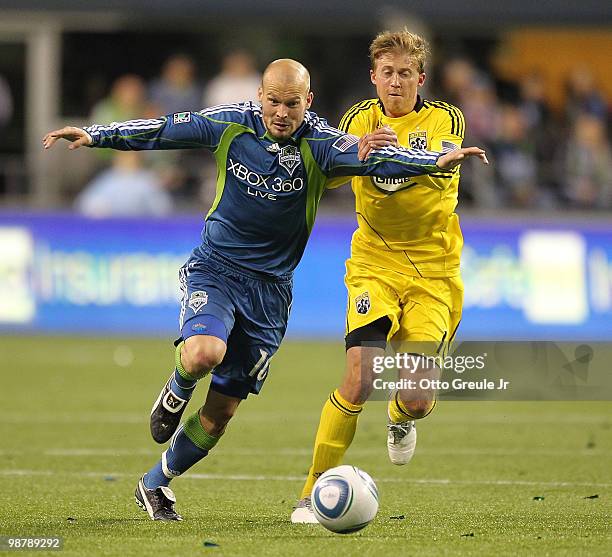 Freddie Ljungberg of the Seattle Sounders FC battles Brian Carroll of the Columbus Crew on May 1, 2010 at Qwest Field in Seattle, Washington.