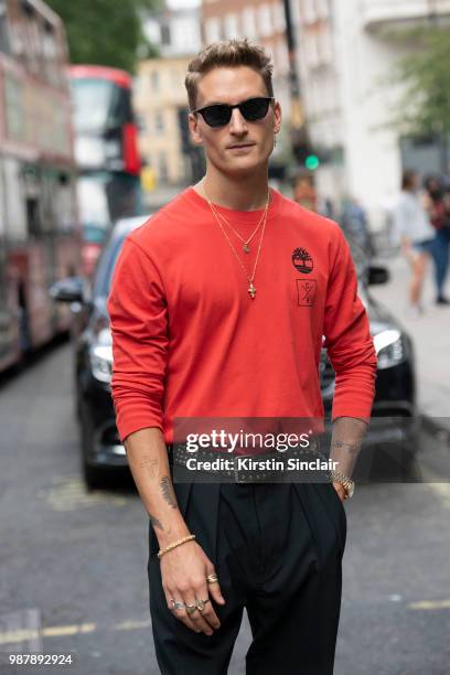 Made in Chelsea star Oliver Proudlock wears a Christopher Raeburn for Timberland top, Tom Davis sunglasses during London Fashion Week Men's on June...