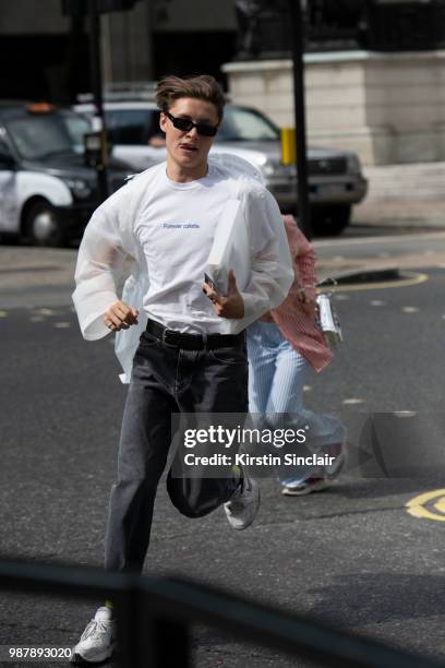 Guest wears a forever Colette T shirt and Nike trainers during London Fashion Week Men's on June 10, 2018 in London, England.