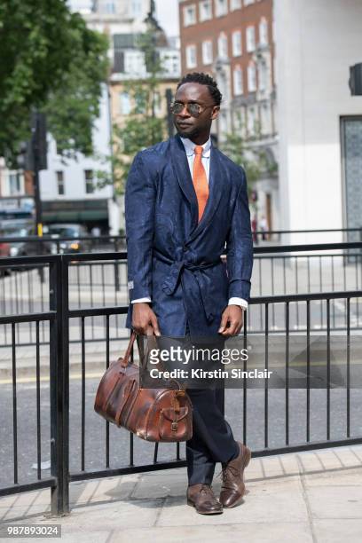 Edmond Kamara wearing a Saran Kohli jacket, Turnbull and Asser Tie, Paul Smith shoes, Garrett Leight sunglasses and a vintage bag during London...
