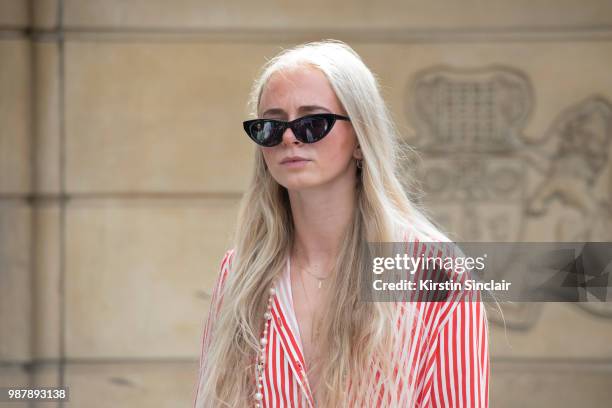 Guest wears a striped shirt during London Fashion Week Men's on June 10, 2018 in London, England.