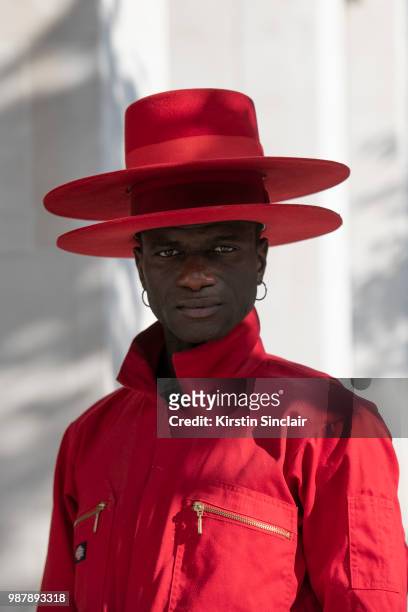 Creative Director and stylist Abdel Keita Tavares wears a Dickies boiler suit and his own design hats during London Fashion Week Men's on June 10,...