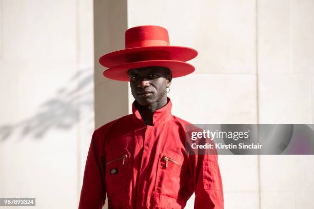 Creative Director and stylist Abdel Keita Tavares wears a Dickies boiler suit and his own design hats during London Fashion Week Men's on June 10,...