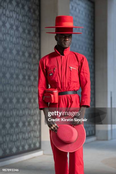 Creative Director and stylist Abdel Keita Tavares wears a Dickies boiler suit and his own design hats during London Fashion Week Men's on June 10,...