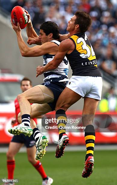 Simon Hogan of the Cats marks infront of Ben Cousins of the Tigers during the round six AFL match between the Geelong Cats and the Richmond Tigers at...