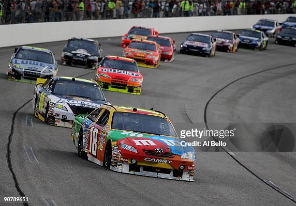 Kyle Busch, driver of the M&M's Toyota, leads the race during the NASCAR Sprint Cup Series Crown Royal Presents the Heath Calhoun 400 at Richmond...