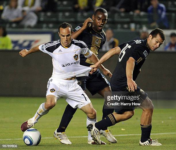 Landon Donovan of the Los Angeles Galaxy spins free from Alejandro Moreno and Amobi Okugo of the Philadelphia Union during the second half at the...